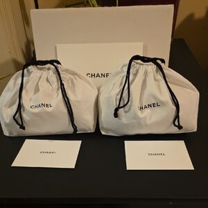 2 Chanel White Dust Bags with Black Drawstrings With Gift Cards.